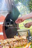 human hands roasting appetizing barbecue on the fire