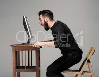 Funny and crazy man using a computer