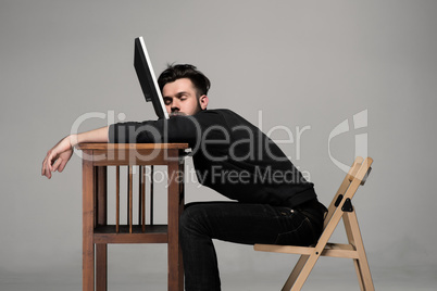 Businessman sleeping on a computer