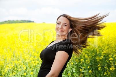 Woman with long brown hair in nature