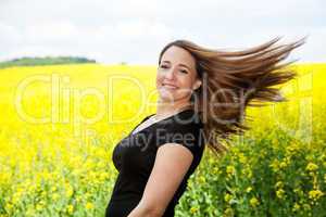 Woman with long brown hair in nature