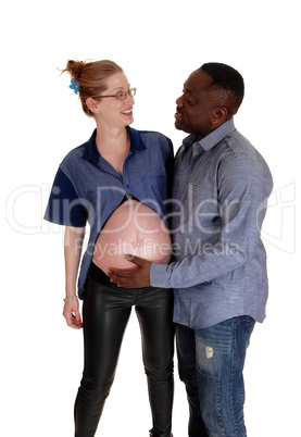 African man holding baby belly of white girl.