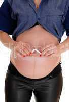 Pregnant woman break's a cigarette.
