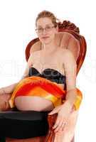 Pregnant woman in armchair.