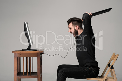 Angry man is destroying a keyboard