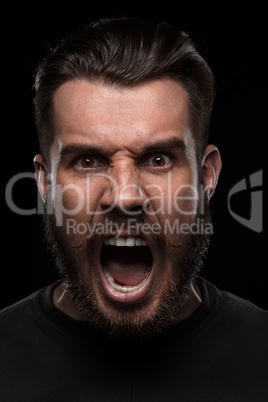 Portrait of young screaming man in studio