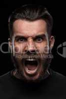 Portrait of young screaming man in studio