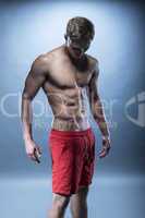 Male fitness model wearing red shorts