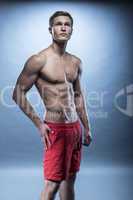 Male fitness model wearing red shorts