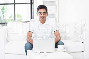 Indian man using computer at home.