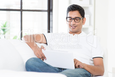 Indian male using digital computer tablet