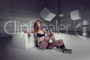 Woman in Lingerie Leaning on Cube in Empty Room