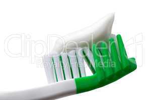 Green toothbrush with toothpaste isolated on white background
