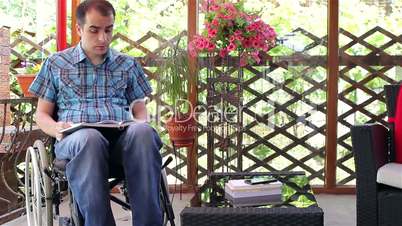 Young man in wheelchair reading