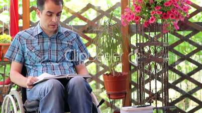 Young man in wheelchair reading