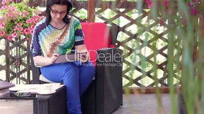 Young woman working on tablet computer outside