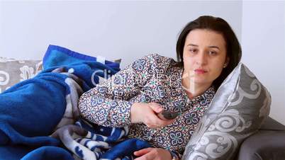 Young woman watching boring movie at TV