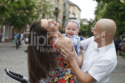 Beautiful happy young family with baby