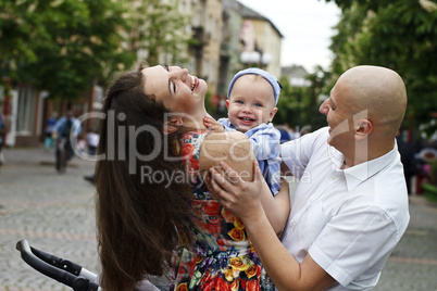 Beautiful happy young family with baby