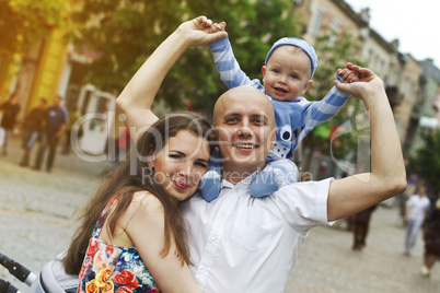 Beautiful happy young family with baby