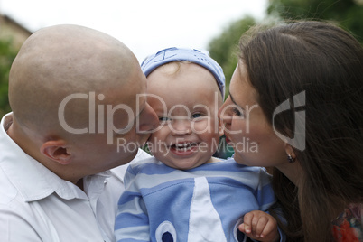 Beautiful happy young family with baby