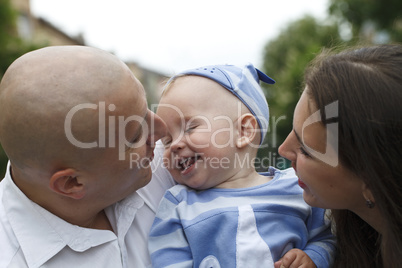 Beautiful happy young family with baby