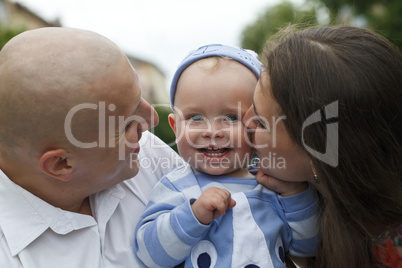 Beautiful happy young family with baby