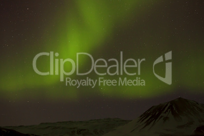 Northern lights with snowy mountains in the foreground Northern lights with snowy mountains in the foreground