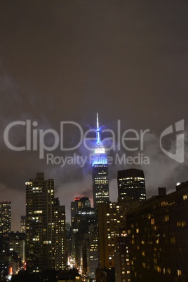 Empire state building between clouds