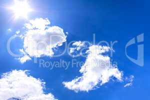 Clouds and sun on blue sky
