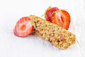 muesli bars with fresh strawberry on white wooden