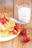 homemade waffles with strawberries maple syrup
