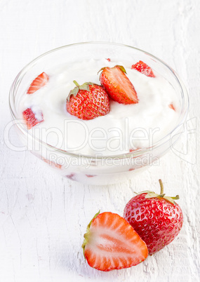 fresh organic yogurt with strawberries on wooden