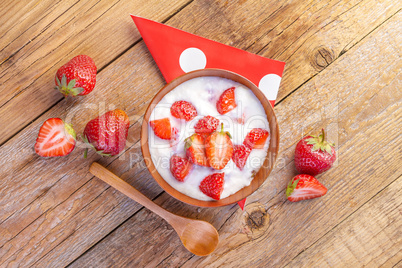 fresh organic greek yogurt with strawberries on wooden