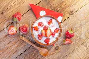 fresh organic greek yogurt with strawberries on wooden