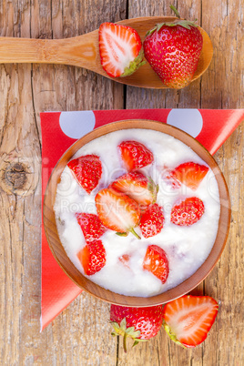 fresh organic greek yogurt with strawberries on wooden