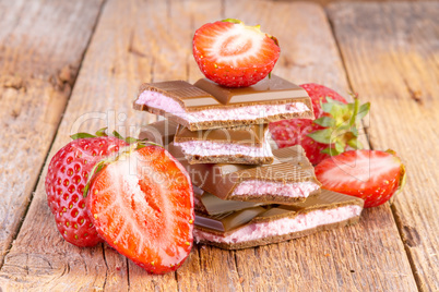 chocolate with strawberry cream on wooden