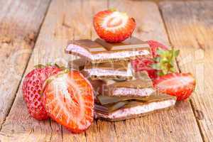 chocolate with strawberry cream on wooden