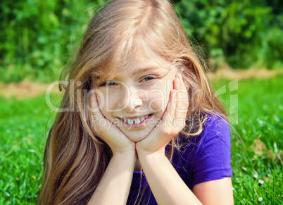 young girl lying on grass