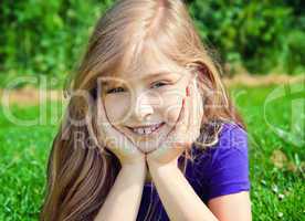 young girl lying on grass