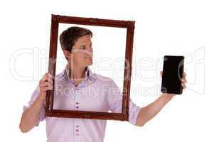 Man looking trough picture frame.