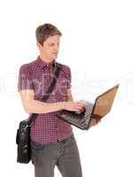 Standing man with laptop.