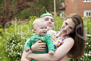 Beautiful happy young family with baby