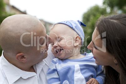 Beautiful happy young family with baby