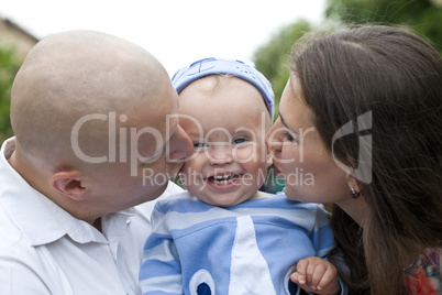 Beautiful happy young family with baby