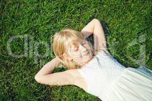 young girl lying on grass