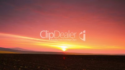 Sunrise over a Plowed Field. Time Lapse
