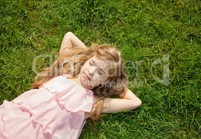 young girl lying on grass