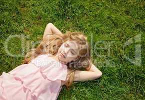 young girl lying on grass