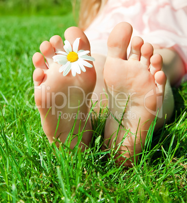 feet of a child with flower